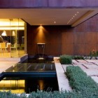 Pond With And Refreshing Pond With Wall Waterfall And Bridge To Reconnect The Indoor And Outdoor Area Of House The Elegantly Dream Homes Eclectic Contemporary Home In Hip And Vibrant Interior Style