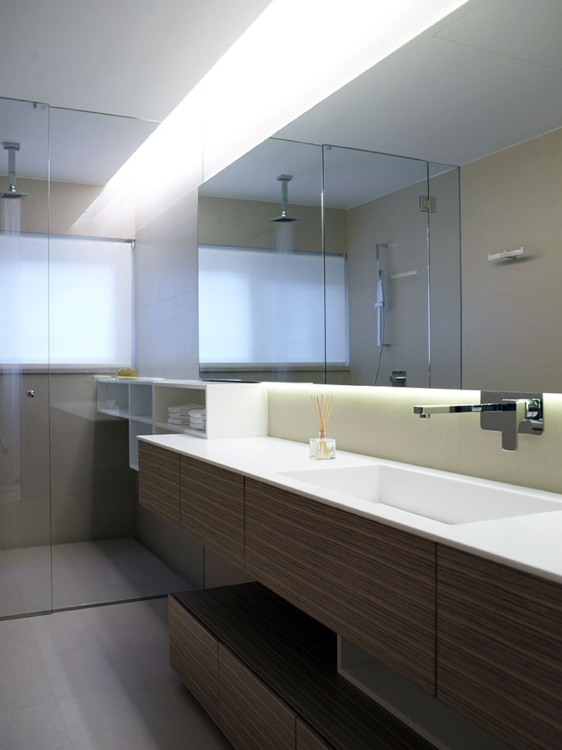 Bathroom Wooden The Sleek Bathroom Wooden Cabinet Under The Mirror Feat Faucet The Panorama Voula Residence And The Lamp Giving Bright The Area Apartments Stylish Contemporary Apartment For Cozy Living Room Placement