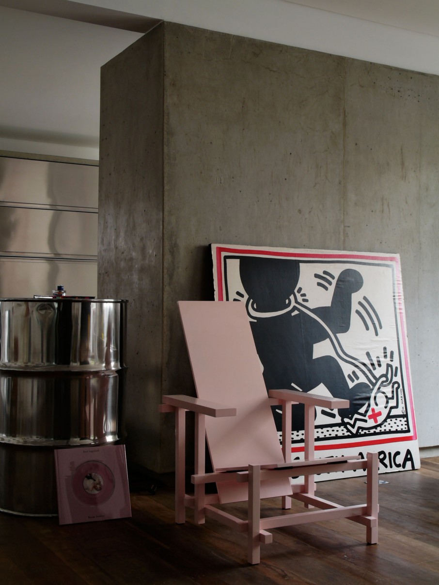 Lazy Chair Dark Unique Lazy Chair Standing On Dark Wood Floor Of Contemporary Houssein Apartment Decorated With Artwork Leaning On Wall Behind Apartments  Fascinating Modern-Industrial Apartment With Beautiful Sophisticated Accent