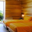 Catching Orange Wooden Eye Catching Orange Bedding On Wooden Platform Twin Beds To Improve Sliding House In Canada Kids Bedroom Architecture Warm Minimalist Cabin With Black Furniture And Modern Fireplace