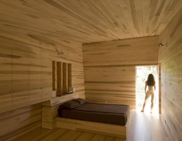 Sliding House Bedroom Nice Sliding House In Canada Bedroom Suite With Hidden Wardrobe On Wooden Wall Installed Next To Platform Bed Architecture  Warm Minimalist Cabin With Black Furniture And Modern Fireplace