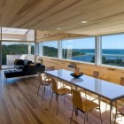 Sliding House Living Open Sliding House In Canada Living Room And Dining Space Interior With Transparency Overlooking Ocean View Architecture Warm Minimalist Cabin With Black Furniture And Modern Fireplace