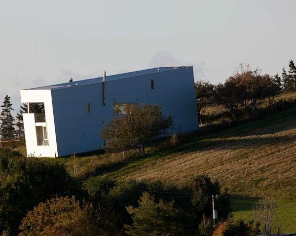 White Painted In Uncommon White Painted Sliding House In Canada Built Purposely In Harmful Position On Asymmetric Ground Architecture  Warm Minimalist Cabin With Black Furniture And Modern Fireplace